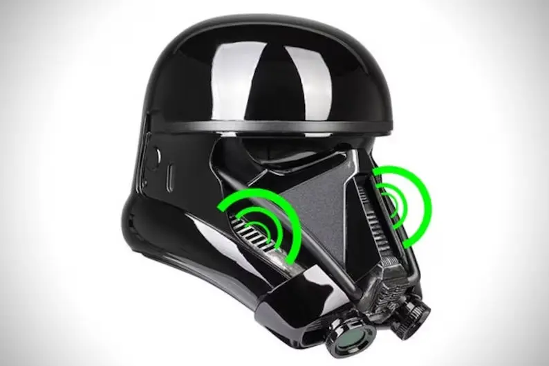 A black helmet with green circles around it.