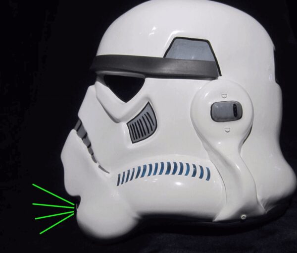 A white helmet with green spikes on it.