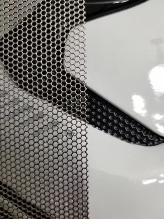 A close up of the metal mesh on a car.