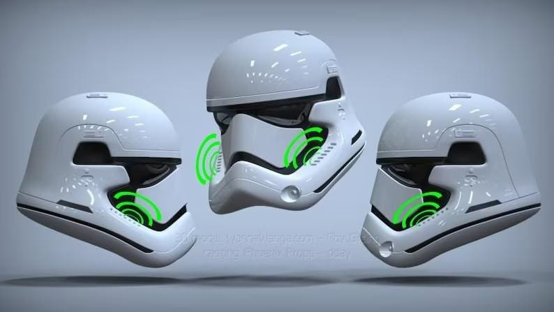 A group of three helmets with green sound waves coming out them.