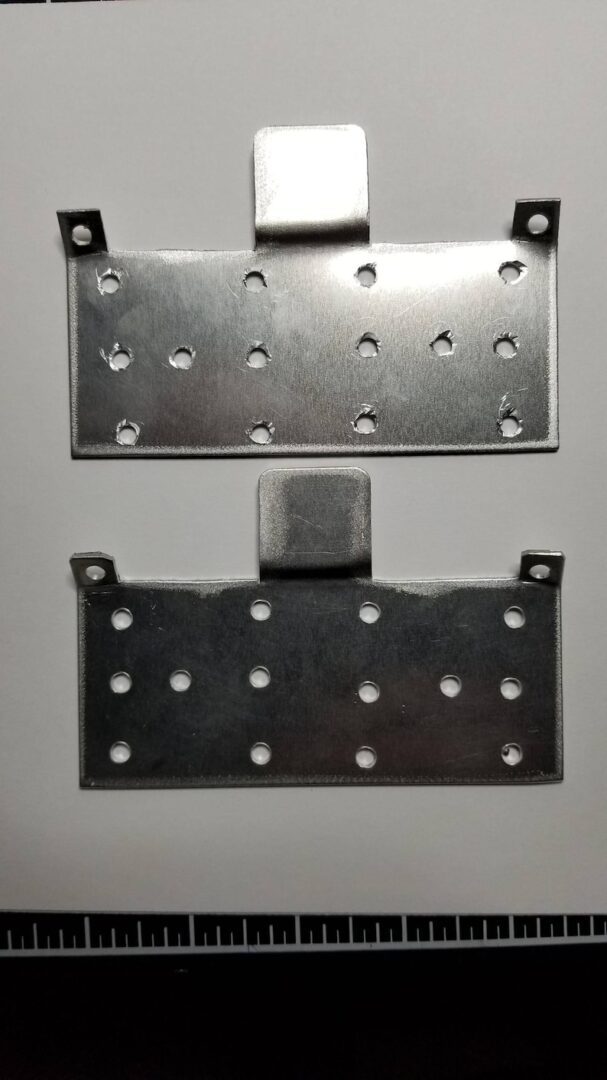 A pair of metal plates with holes in them.