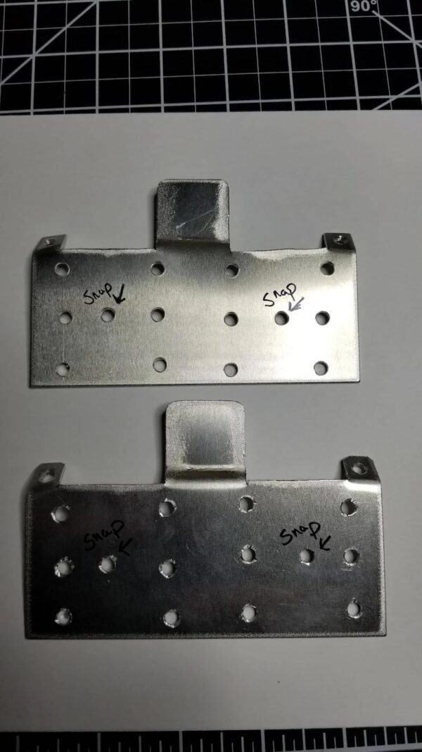 A pair of metal plates with holes on them.