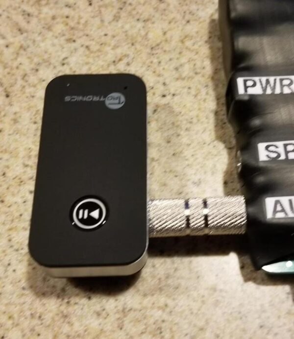 A black and silver phone sitting on top of a table.