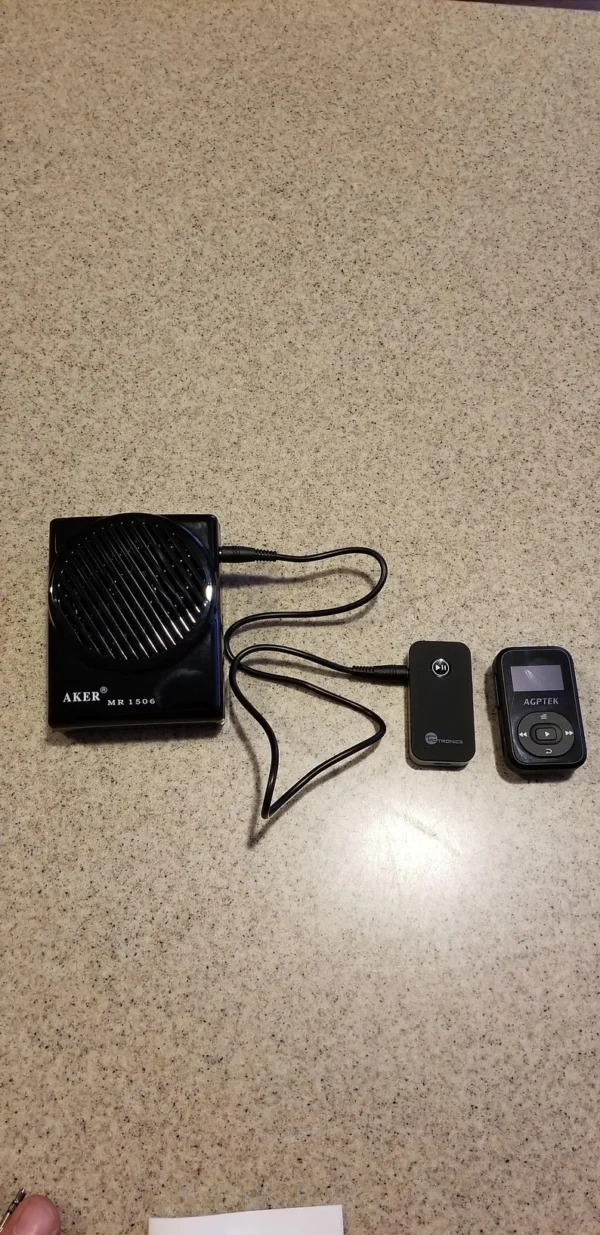 A small black device and two other devices on the floor.