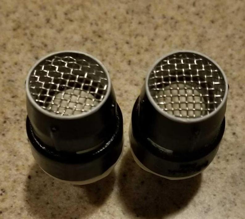 Two metal cups with a mesh design on them.