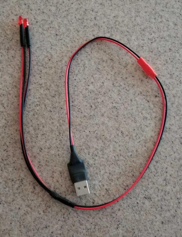 A red and black cord is connected to a usb cable.