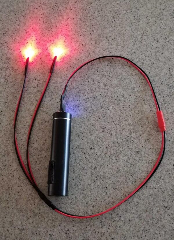 A small device with two red and one blue lights.