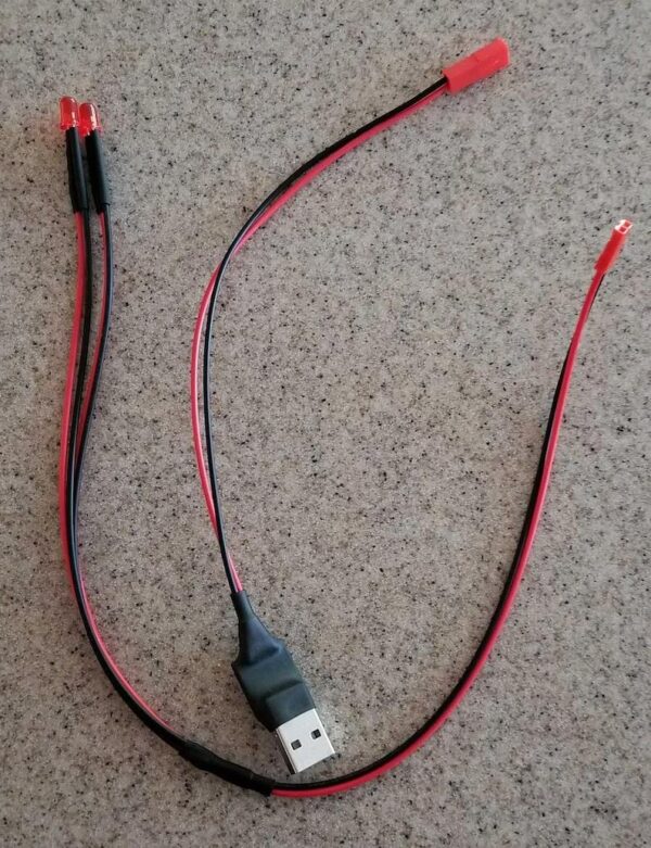 A red and black cord is connected to a usb cable.