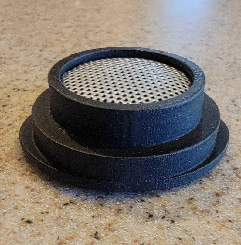 A black plastic cup holder with a mesh lid.