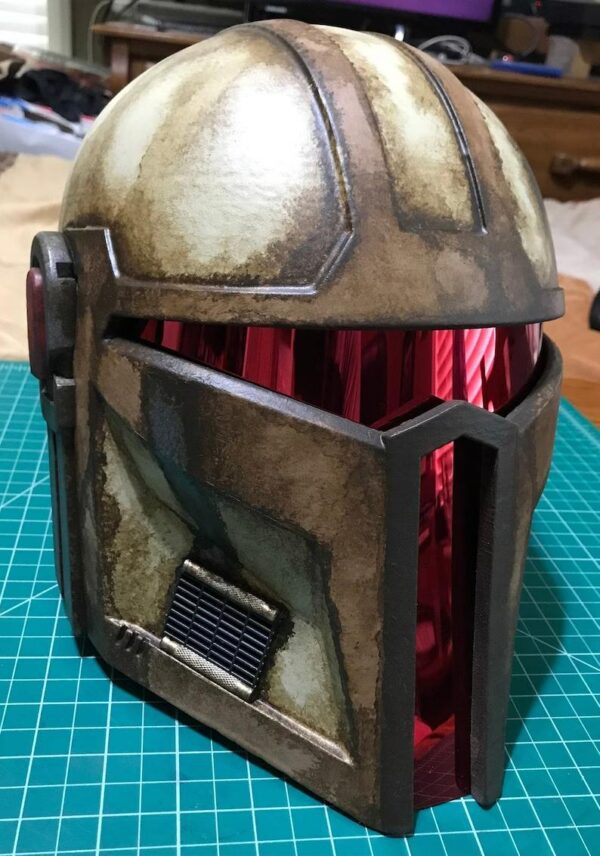 A paper model of a helmet with a red lining.