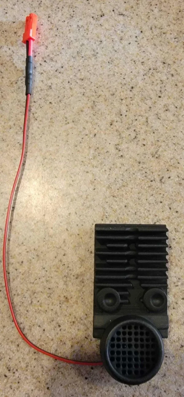 A black square shaped object sitting on top of a floor.