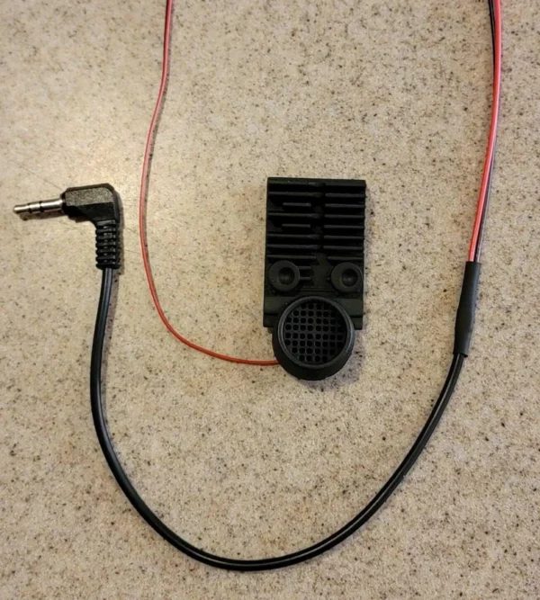 A black cord with an electronic device attached to it.