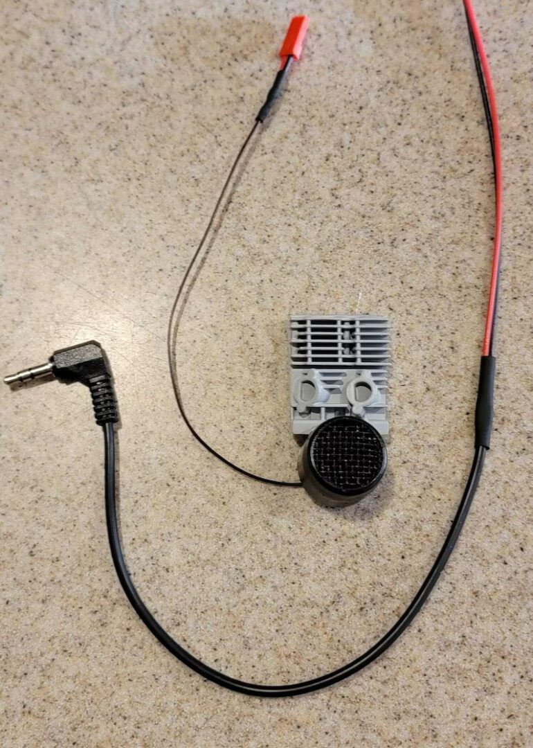 A small device is connected to the wires.