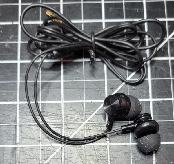 A pair of earbuds sitting on top of a floor.